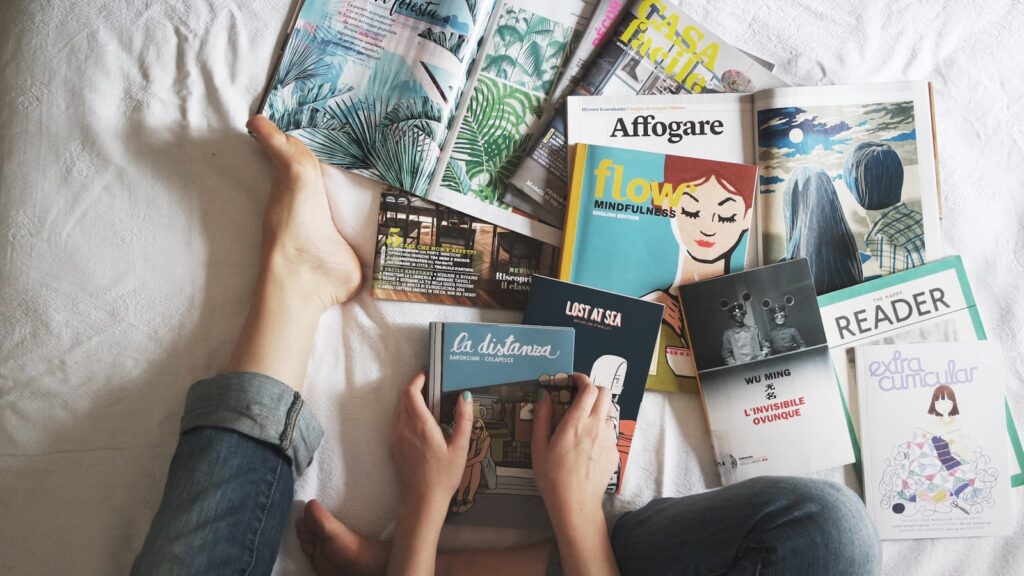 a stack of magazines sitting on top of a wooden table. They cover sustainability themes like agroforestry economy, esg economy, climate-action innovation, climate-change, agriculture, circular economy